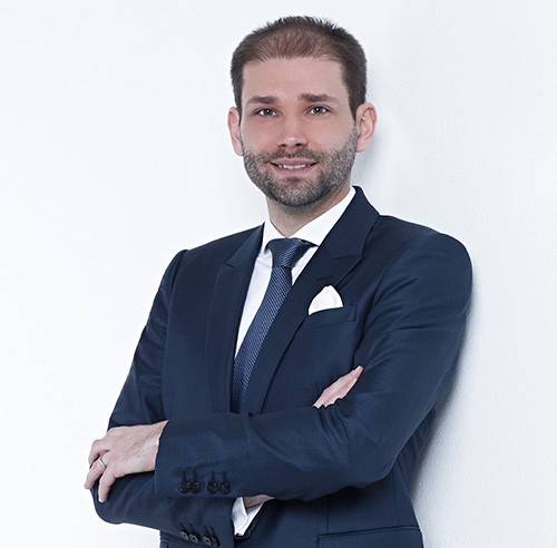Smiling businessman standing in the office